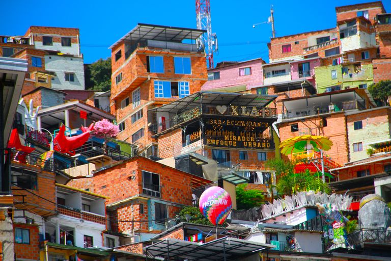 Explore the colorful hillside buildings and urban art of Medellín's Comuna 13, a culture-rich neighborhood.