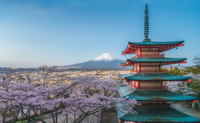 Chureito Pagoda with blooming cherry blossoms and Mount Fuji visible in the background.